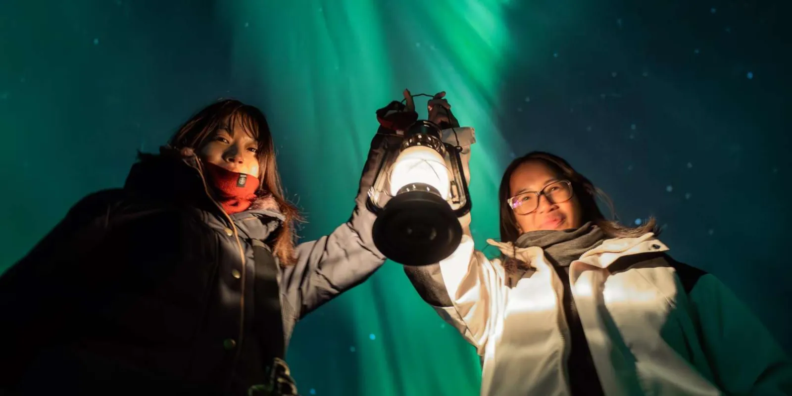 Bright green Northern Lights streaking across the starry sky over snowy Lapland